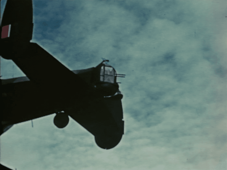 Silhouette of a bomber's tail turret against the sky